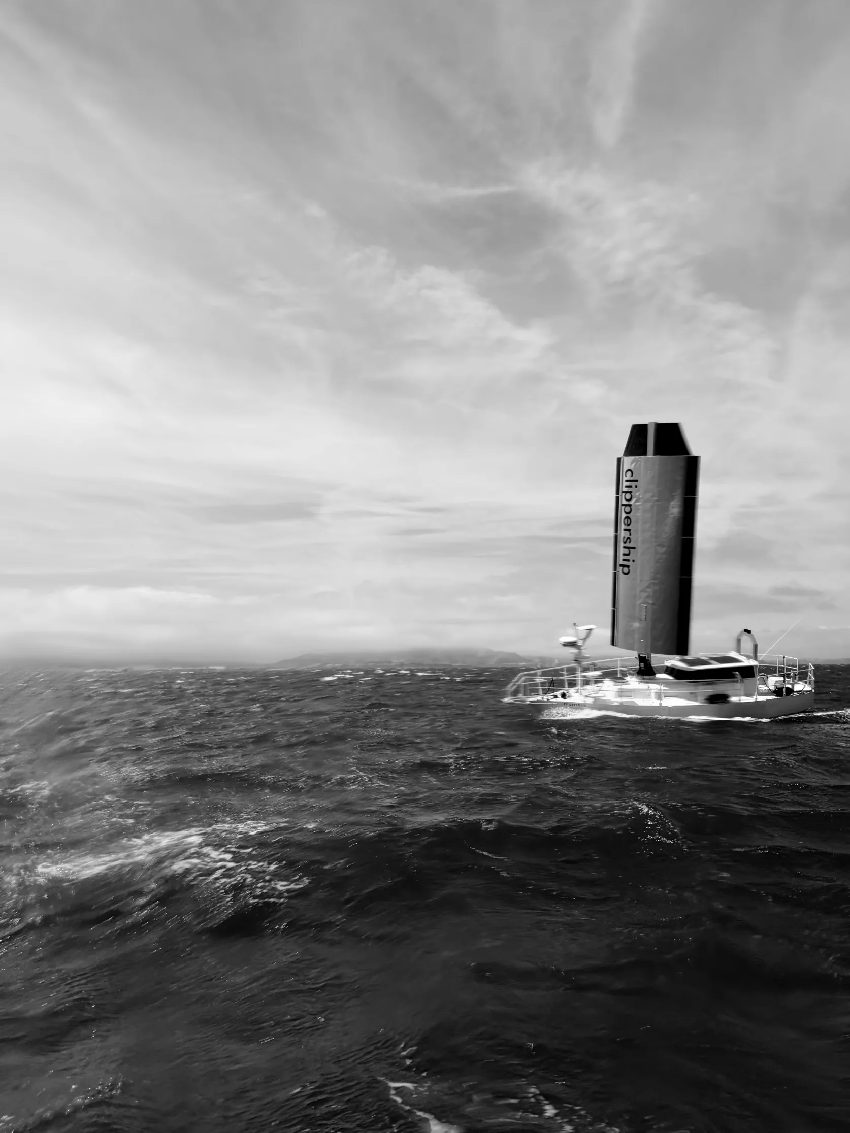 Vessel under sail in open ocean, monochrome